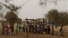 FILE - Women crowd a well in the village of Kiral, near Goudoude Diobe in the Matam region of northeastern Senegal.