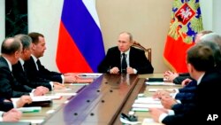 FILE - Russian President Vladimir Putin, center, leads a Security Council meeting in Moscow, Russia, March 30, 2018.