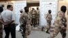 Pakistani paramilitary troops raid the Muttahida Quami Movement's offices in Karachi, March 11, 2015.