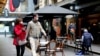 FILE - People walk past a cafe after the coronavirus disease restrictions were eased for the state of Victoria, in Melbourne, Australia, Oct. 28, 2020. 