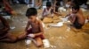 Children fill up empty cigarettes manually with locally grown tobacco in a small factory at Haragach in Rangpur district, Bangladesh, in this July 11, 2013, file photo. 
