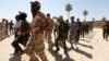 Shi'ite volunteers, who have joined the Iraqi army to fight against militants of the Islamic State, formerly known as the Islamic State in Iraq and the Levant (ISIL), march during training in Baghdad, July 9, 2014. 
