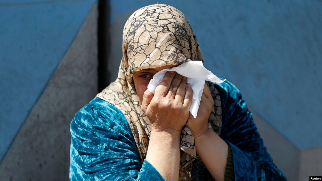A Palestinian woman who fled the violence in Syria reacts during a sit-in in front of the United Nations Relief and Works Agency (UNRWA) in Beirut, Lwbanon, March 21, 2013. 