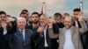 Senior Fatah official Azzam Al-Ahmed (L), head of the Hamas government Ismail Haniyeh (C) and senior Hamas leader Moussa Abu Marzouq hold their hands after announcing a reconciliation agreement in Gaza City, April 23, 2014.
