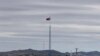 FILE - A North Korean flag flutters in the wind atop a tower in North Korea's village of Gijungdongseen, as seen from the Taesungdong freedom village inside the demilitarized zone in Paju, South Korea, April 27, 2018. 