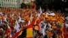 People wave flags of Catalonia and Spain as they celebrate a holiday known as "Dia de la Hispanidad" or Spain's National Day in Barcelona, Spain, Oct. 12, 2017.