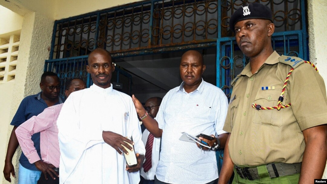Detectives escort Ezekiel Ombok Odero at the police headquarters in Mombasa