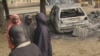 Children stand near the scene of an explosion in a mobile phone market in Potiskum, Nigeria, Jan. 12, 2015. 