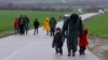Migrants walk along a road from the village of Chamilo to the migrant camp at the village of Idomeni, near the Greek-Macedonian border, Greece, March 15, 2016.