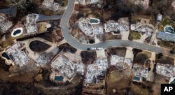 FILE - Homes leveled by the Camp Fire line Valley Ridge Drive in Paradise, Calif., Dec. 3, 2018.