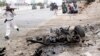A Somali soldier runs to fight near the wreckage of a car bomb during an attack on Somalia's parliament, Saturday, May 24, 2014. 