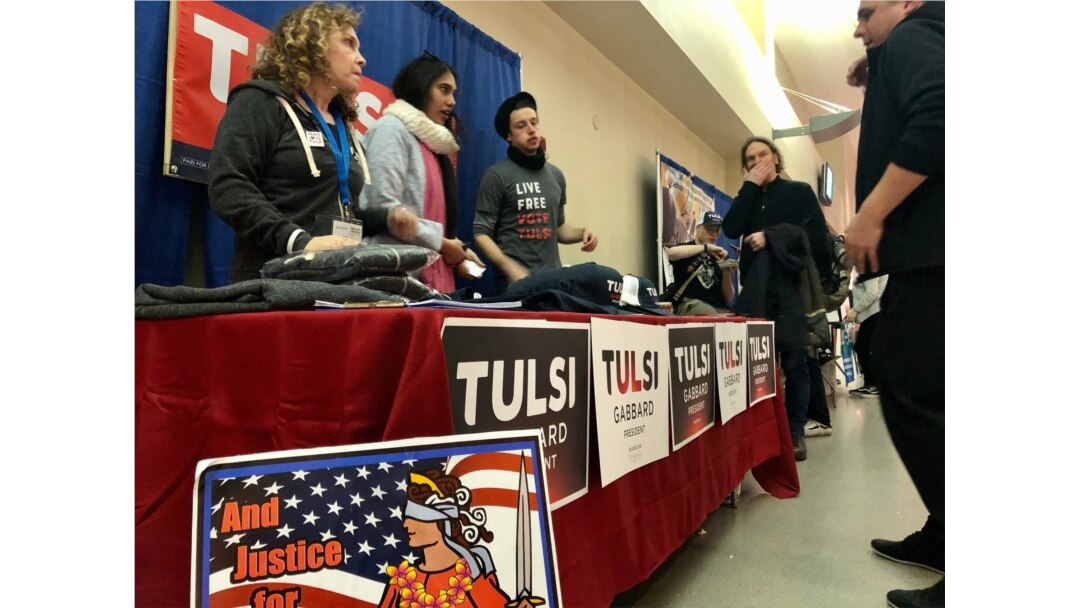 Eileen Tepper, left, and other supporters greet a voter asking about issues supported by now former Democratic presidential candidate Tulsi Gabbard. Gabbard dropped out of the race March 19. (Carolyn Presutti/VOA)