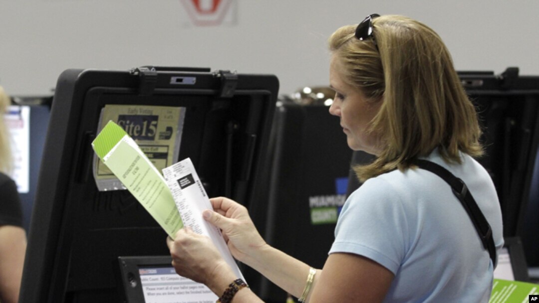 A voter checks her ballot during early voting in Miami, Florida