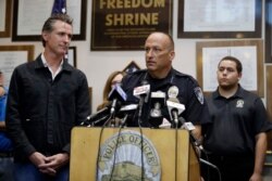 Ridgecrest Police Chief Jed McLaughlin, right, speaks as California Gov. Gavin Newsom listens, July 6, 2019, in Ridgecrest, Calif. Crews in Southern California assessed damage Saturday after the largest earthquake the region has seen in 20 years.
