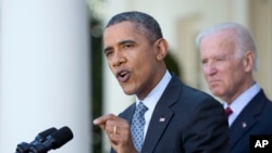President Barack Obama, accompanied by Vice President Joe Biden speaks about the Affordable Care Act, April 1, 2014, in the Rose Garden of the White House.
