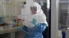 A laboratory specialist examines specimens of the Ebola virus at the Uganda virus research center in Entebbe, 40km south of the capital Kampala, May 17, 2011. 