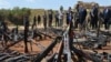 French President Francois Hollande, third right, and his Defense Minister Jean-Yves Le Drian, second right, inspect arms confiscated from ex-Seleka rebels and Anti-balaka militia by the French military of operation Sangaris, and displayed at a French mili