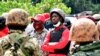 Ugandan opposition presidential candidate Robert Kyagulanyi, also known as Bobi Wine, is escorted by policemen during his arrest in Kalangala in central Uganda, Dec. 30, 2020. 