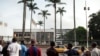 People look at the damaged building of Cameroon's parliament on November 17, 2017 in Yaounde, after a fire swept through the main building overnight, causing substantial damage.