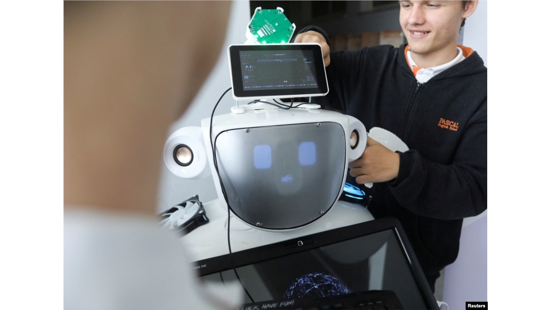 High school students Konstantinos Timinis and Vladimir Baranov work on "Alnstein", a robot powered by ChatGPT, in Pascal school in Nicosia, Cyprus on March 30, 2023. (REUTERS/Yiannis Kourtoglou)