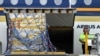 The first Australian shipment of Pfizer coronavirus disease (COVID-19) vaccines is unloaded from a Singapore Airlines plane at Sydney International Airport, Feb. 15, 2021.