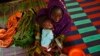Bonko Diawara holds her 17-month-old daughter, Diarra Yattibere, as she recovers from malnutrition, at a nutrition center at Selibaby's hospital, in the Guidimakha region, Mauritania, June 2012.