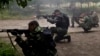 Pro-Russian rebels fire weapons during clashes with Ukrainian troops on the outskirts of Luhansk, Ukraine, June 2, 2014. 