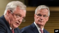 The EU chief Brexit negotiator Michel Barnier, right, and British Secretary of State David Davis address the media at EU headquarters in Brussels, July 20, 2017.