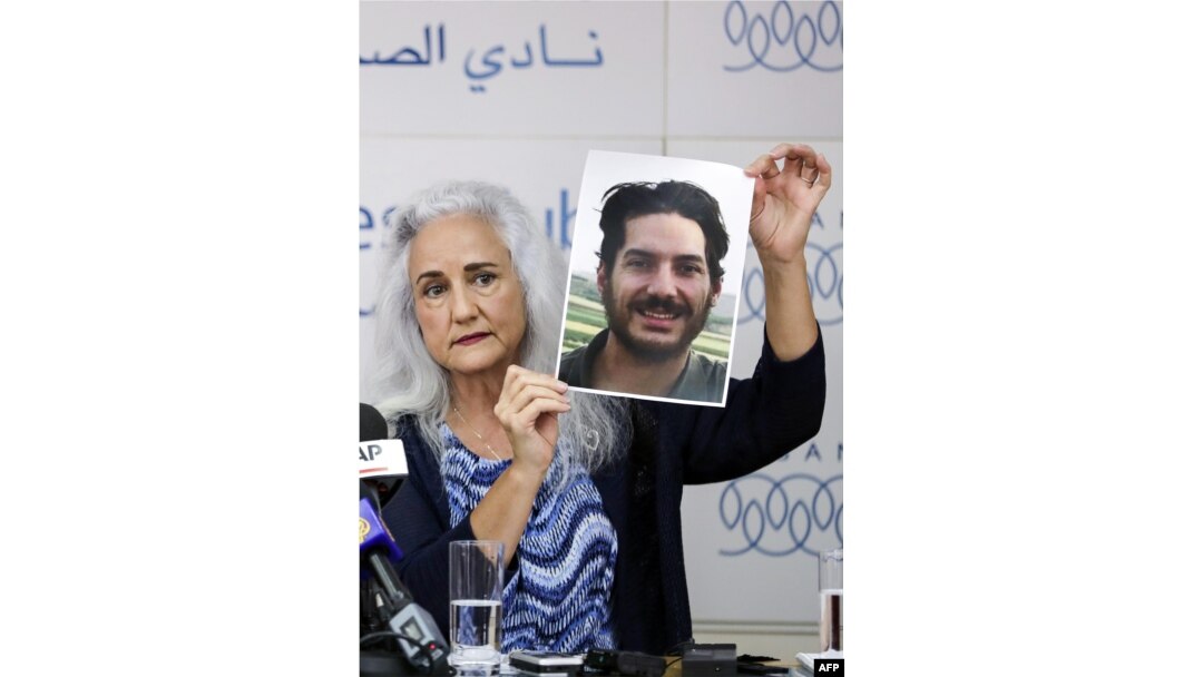 Debra Tice, mother of U.S. journalist Austin Tice, who was kidnapped in Syria five years ago, holds a dated portrait of him during a press conference in Beirut, Lebanon, July 20, 2017.
