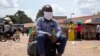A boy sits on a bag at the old taxi park in Kampala, Uganda, on June 4, 2020, the first day of the reopening of public transport. 