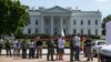 Demonstrators are lined up outside the White House in Washington, Aug. 28, 2014, as they are being arrested during a protest on immigration reform.