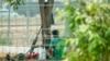 FILE - Myanmar soldiers are seen on the Myanmar side of a bridge across the Moei River linking to the district of Mae Sot in Thailand's Tak province on Thursday, April 11, 2024.