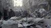 Residents inspect damage after airstrikes by Syrian government forces in the rebel-held Al-Shaar neighborhood of Aleppo, Syria, Feb. 4, 2016. 