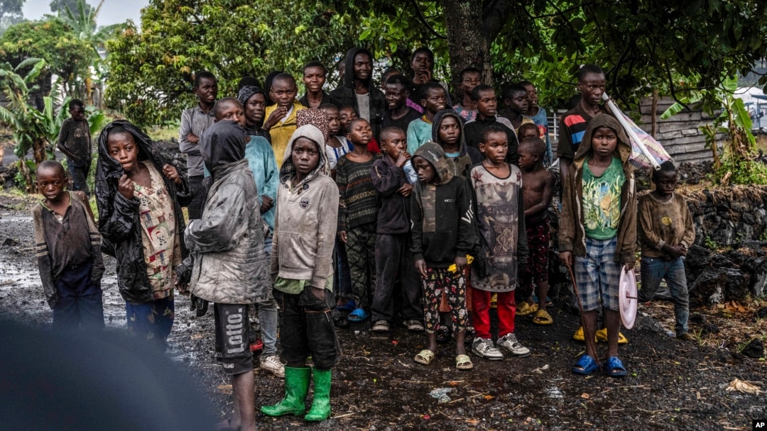 FILE - Congolese children watch the deployment of government and U.N. troops outside Goma, Democratic Republic of Congo, Jan. 24, 2025, as M23 rebels are reported to be closing in on the town. 