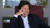 Imran Khan, Pakistani cricketer turned politician, gestures during an interview with at his residence in Islamabad, November 16, 2011.