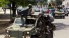 Military vehicles lead the way as South African President Jacob Zuma arrives as the head of an Africa Union-lead delegation in an attempt to broker dialogue to end months of violence in Burundi's capital Bujumbura, Feb. 25, 2016.