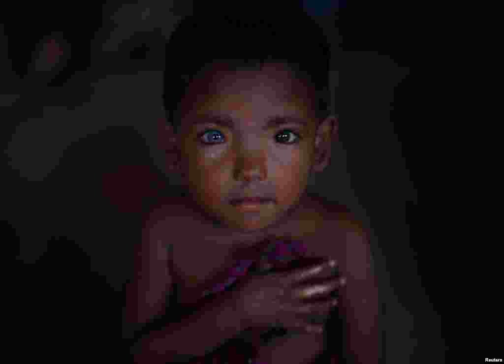 Hosne Ara, 4, a Rohingya refugee who fled Myanmar two-months ago listens to children singing at a children&#39;s center in the Kutupalong refugee camp near Cox&#39;s Bazar, Bangladesh.