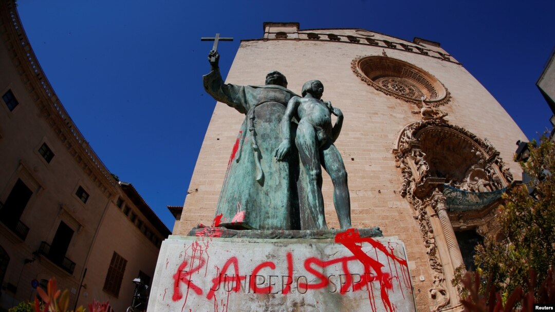 A graffiti reading "racist" is seen on a statue of Fray Junipero Serra in Palma de Mallorca, Spain, June 22, 2020.