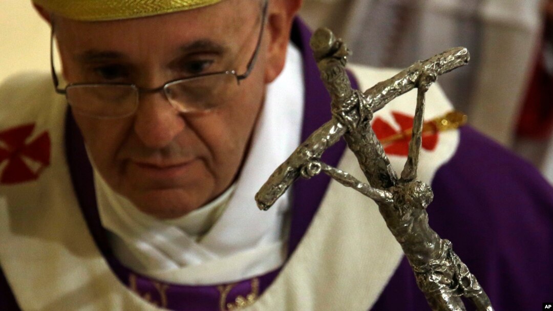 Pope Francis leaves at the end of a Mass on the occasion of his visit to the Parish Church of St. Cirillo Alessandrino, in Rome, Dec. 1, 2013.