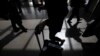 Passengers cast shadows as they walk along a terminal at Los Angeles International Airport in Los Angeles, California, March 4, 2013. 