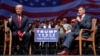 Republican presidential candidate Donald Trump gives a thumbs up as he speaks with retired Lt. Gen. Michael Flynn during a town hall in Virginia Beach, Va., Sept. 6, 2016.