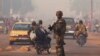A French soldier waves through traffic as he mans a roadblock in the Miskine neighborhood of Bangui, Central African Republic, Jan. 6, 2014. 
