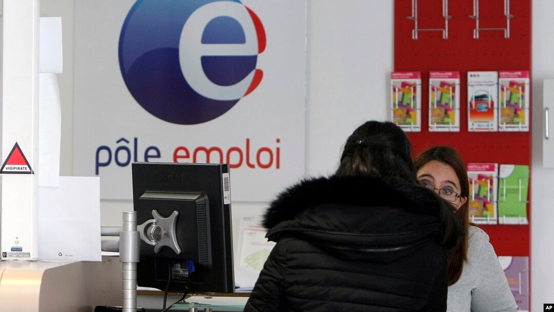 A job seeker speaks to a clerk at an Employment Center in Marseille, southern France, Feb. 24, 2015. Record-high unemployment started dragging French President Francois Hollande's popularity down just a few months after his election in 2012.