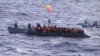 FILE: Migrants receive help from two raft from the Italian Navy ship Libra, off the Sicilian island of Lampedusa Saturday, Oct.12, 2013. 