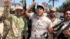FILE - Volunteers, who have joined the Iraqi Army to fight against Sunni militant group Islamic State of Iraq and the Levant (ISIL), carry weapons during a parade in the city of Baquba, June 23, 2014.