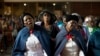Women sing during a mass commemorating late South African former president Nelson Mandela on December 8, 2013 in Soweto, near Johannesburg. 