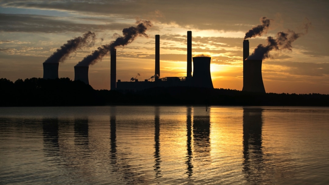 FILE - The coal-fired Plant Scherer, one of the nation's top carbon dioxide emitters, stands in the distance in Juliette, Ga., June 3, 2017. The Trump administration intends to roll back the centerpiece of former President Barack Obama’s efforts to slow g