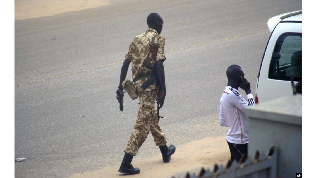 FILE - A South Sudan soldier patrols the street in Juba, South Sudan, July 11, 2016.
