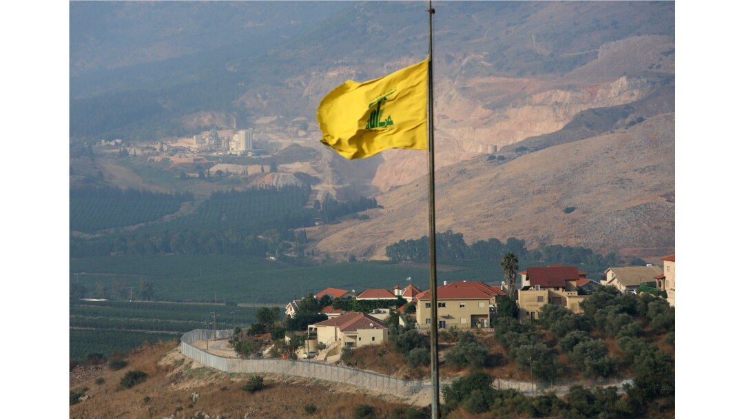 FILE - A Hezbollah flag flutters in the southern Lebanese village of Khiam, near the border with Israel, Lebanon, July 28, 2020.