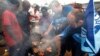 Rugby fans pour some beer on their braai meat , Soweto, South Africa, May 29, 2010 file photo.